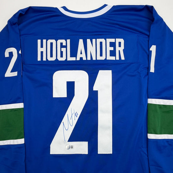 Autographed/Signed Nils Hoglander Vancouver Blue Hockey Jersey Beckett BAS COA