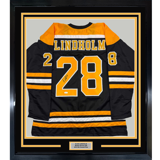 Framed Autographed/Signed Elias Lindholm 35x39 Boston Black Hockey Jersey JSA COA