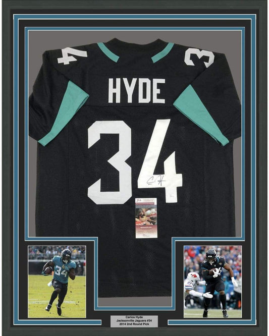 Framed Autographed/Signed Carlos Hyde 35x39 Jacksonville Black Football Jersey JSA COA